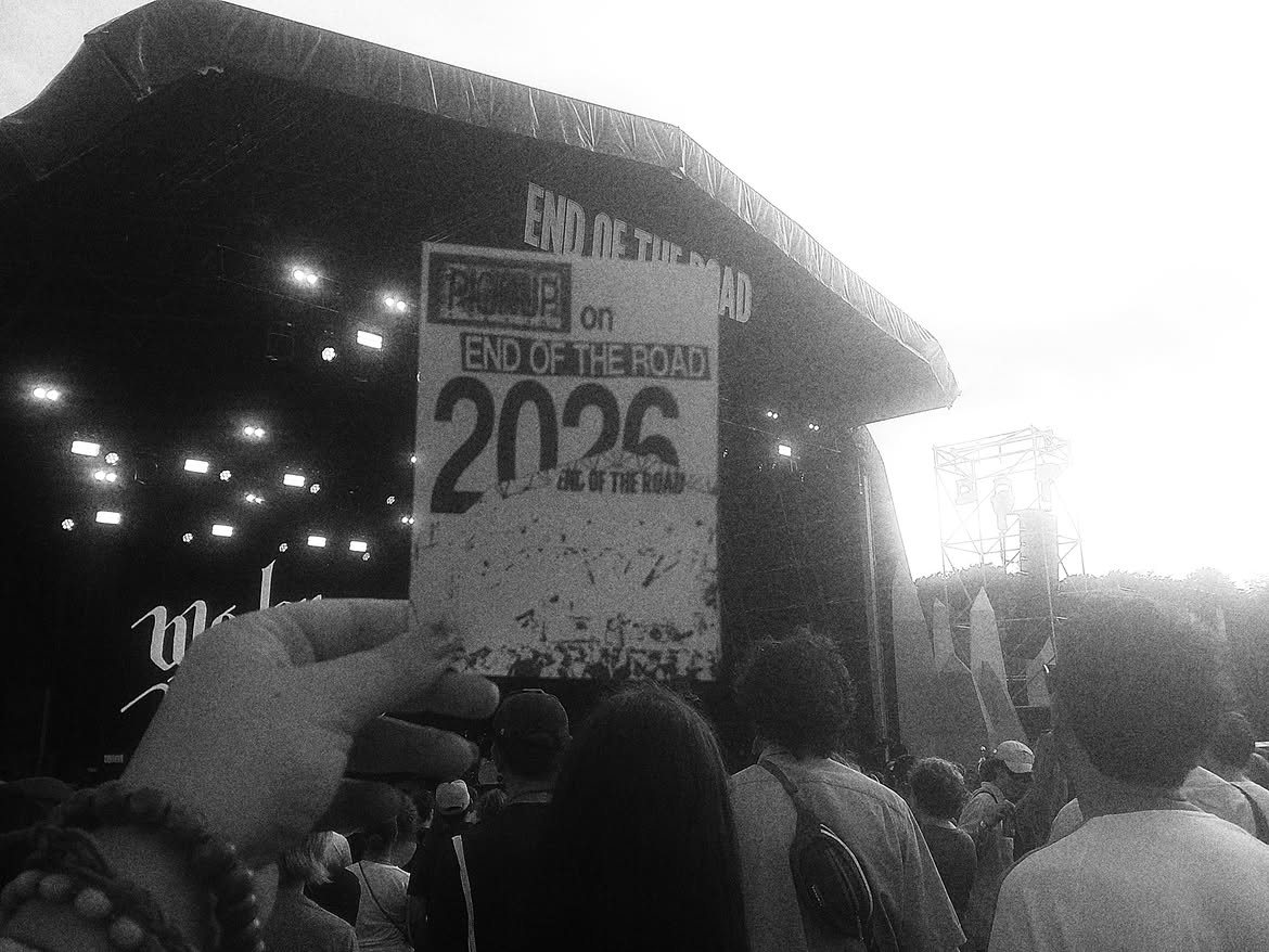 The PICKUP End of the Road zine held up in front of the main stage